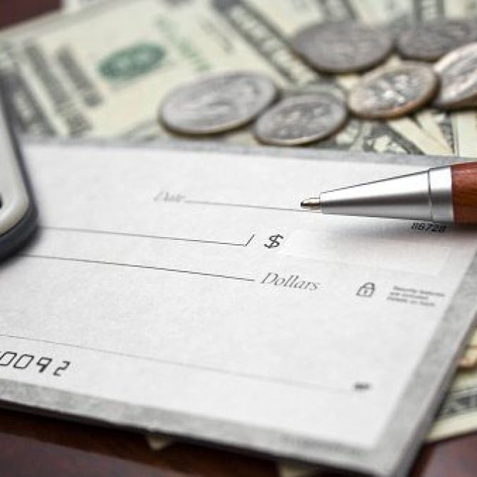 Close up image of pen over pay check, money, and coins
[b]For more similar images click [url=http://www.istockphoto.com/file_search.php?action=file&lightboxID=5593648]Here[/url][/b]